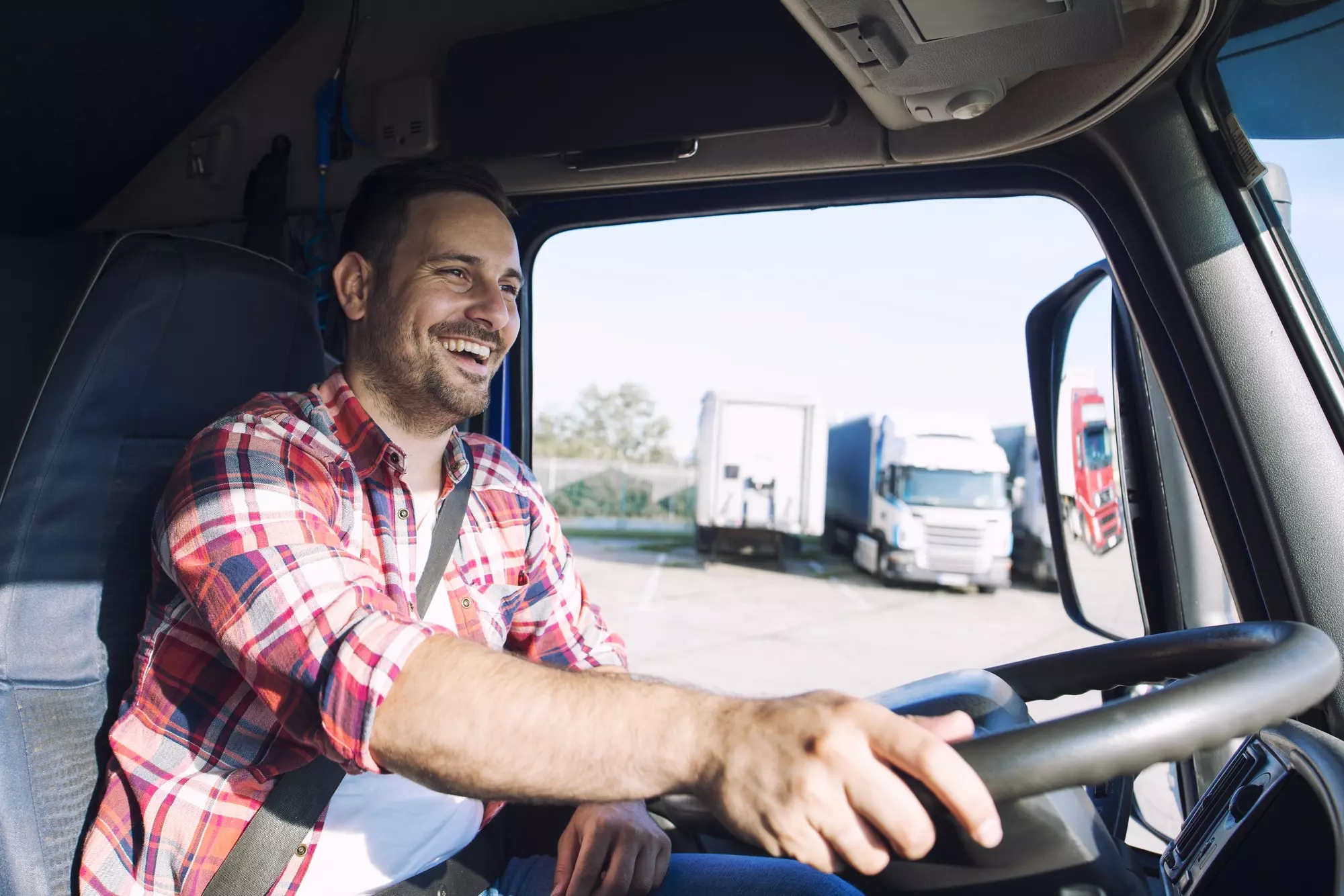 professional-middle-aged-truck-driver-casual-clothes-driving-truck-vehicle-delivering-cargo-destination